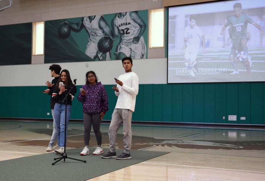 Giovanni Rofa (12), Meona Khetrapal (11), Rohan Varma (11) and Adhya Hoskote (12) deliver the Eagle Update during Tuesday's school meeting. They reviewed the results from recent games played by the girls basketball, girls soccer, boys basketball and girls basketball.