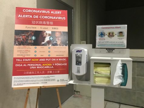 A warning sign with information about coronavirus and a station with hand sanitizer, tissues and face masks stand outside the entrance doors to the emergency room of Good Samaritan Hospital in San Jose, CA. As of March 2, there are 9 confirmed cases of COVID-19 in Santa Clara County.