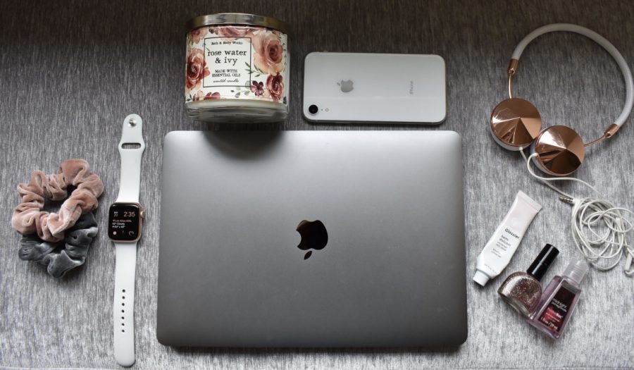 My pandemic survival kit includes my laptop, phone, Apple Watch, headphones, lip balm, nail polish, hand sanitizer, candle and scrunchies. These daily essentials keep me occupied at home during this difficult time.