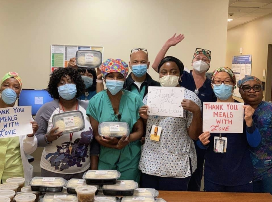Medical staff from Highland Hospital in Oakland hold up thank you signs after receiving a delivery from Meal with Love. The initiative to bring meals to medical workers who lack the time to cook amid the COVID-19 pandemic began on April 3 by three women including upper school parent Cindy Liu. 