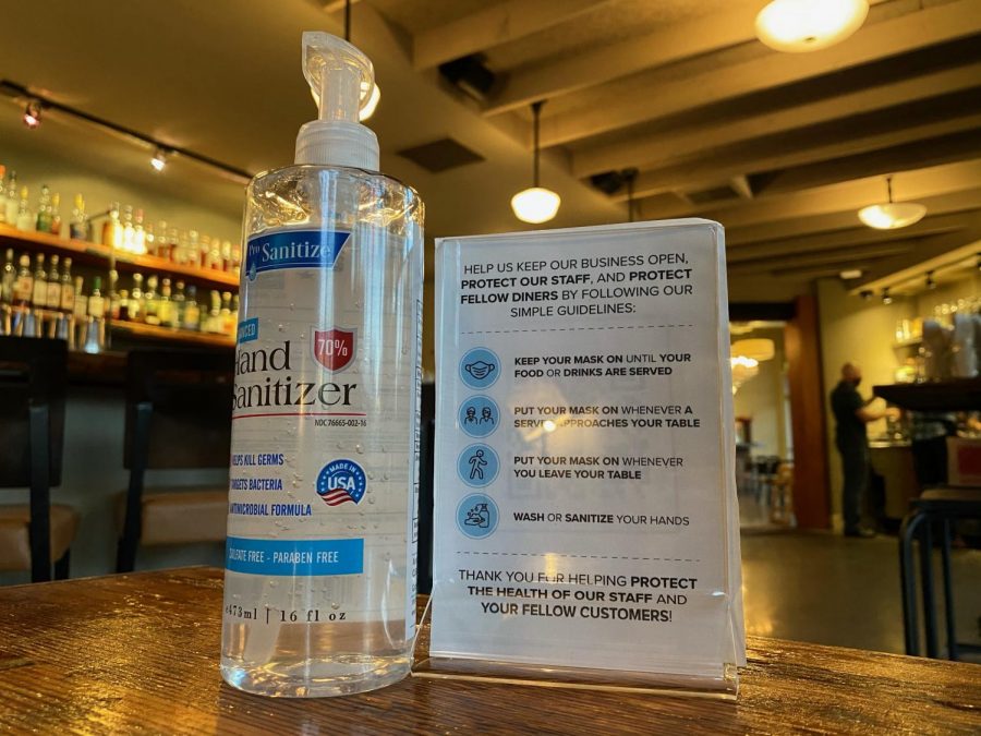 Hand sanitizer and COVID-19 guidelines at The Table in San Jose. “I thought that people would be really excited to come and eat here, but even from the get-go you still have people that were going to be unhappy. Unfortunately, sometimes it is taken out on people like essential workers,” manager Alisha Lorenz said. 