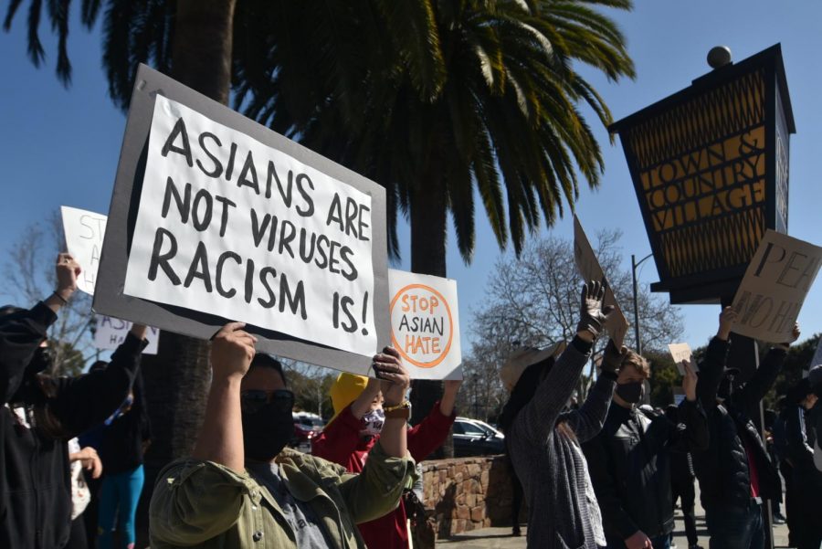 Protestors hold up a signs to rally against the recent racist attacks against Asian Americans at Palo Alto on March 21. 