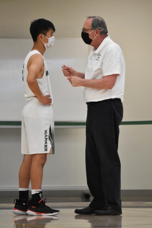 Varsity basketball head coach Butch Keller speaks with co-captain Ray Wang (12) during the team’s match against Silver Creek. The team still has eight matches left to play on their league schedule.