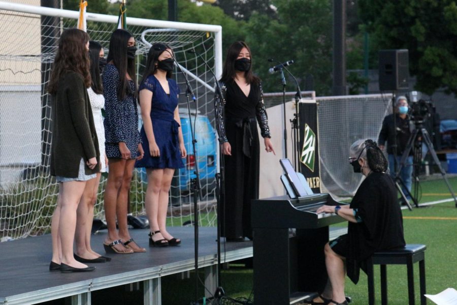 Vocal group Cantilena sings onstage at Baccalaureate while upper school vocal teacher Susan Nace plays the piano. Cantilena performed after Sophia Horng (12) played a piece on the violin. 