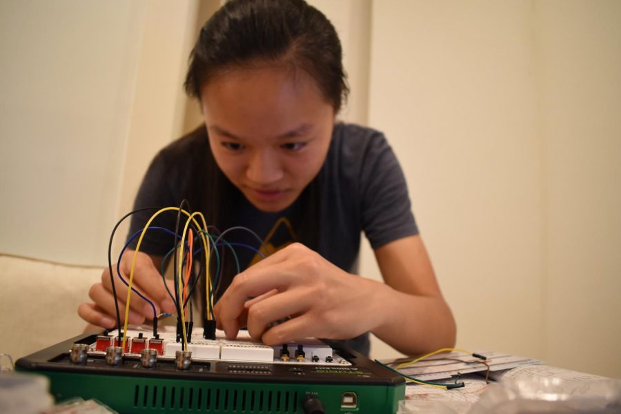 Teresa Cai (12) tinkers with circuits as part of her work in the Research in Science and Engineering (RISE) program at Boston University. Interns collaborated virtually with their mentors and presented their research at the end of the 6-week-long program.