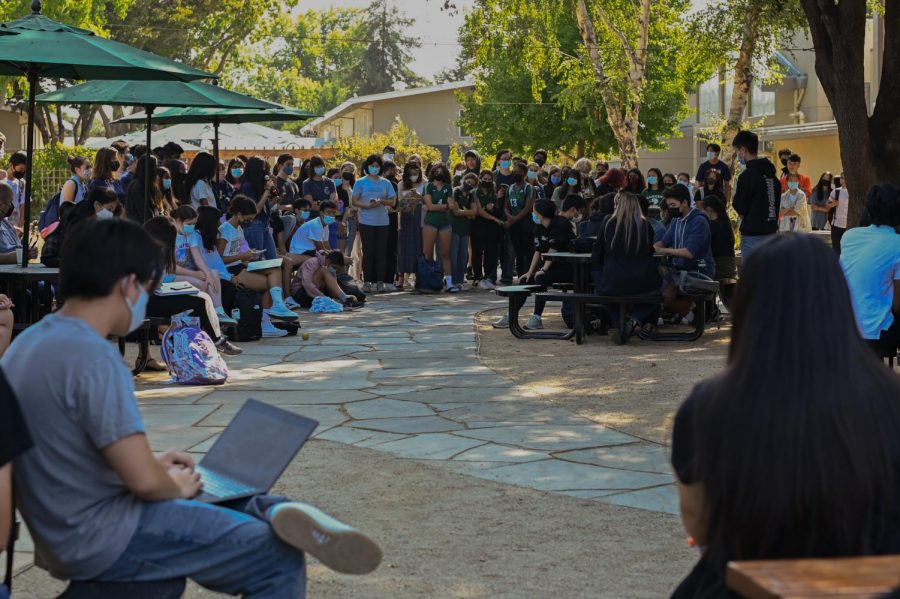 Students and faculty gather in a circle around the Quad on Thursday during the town hall. Students brought up various points, including concerns about not allowing athletic shorts and enforcing the fingertip length rule.