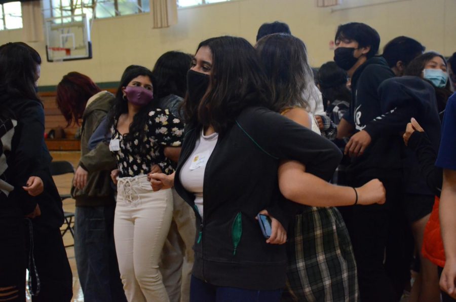 Samvita Gautham (11) dances with a partner during one of the bonding activities. After upper school participants linked arms and danced to music, they turned around and shared their answers to a prompting question introduced by a Challenge Day facilitator.