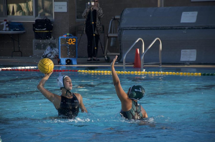 Deeya Kumar (11) attempts to block Palo Alto player's pass attempt. The varsity girls water polo team is now ranked fourth in league with a record of 6-6.