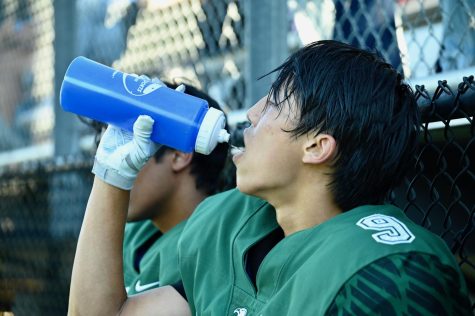Zeke Wang (11) drinks water on the sideline during the varsity football teams match against Valley Christian on Sept. 10. 