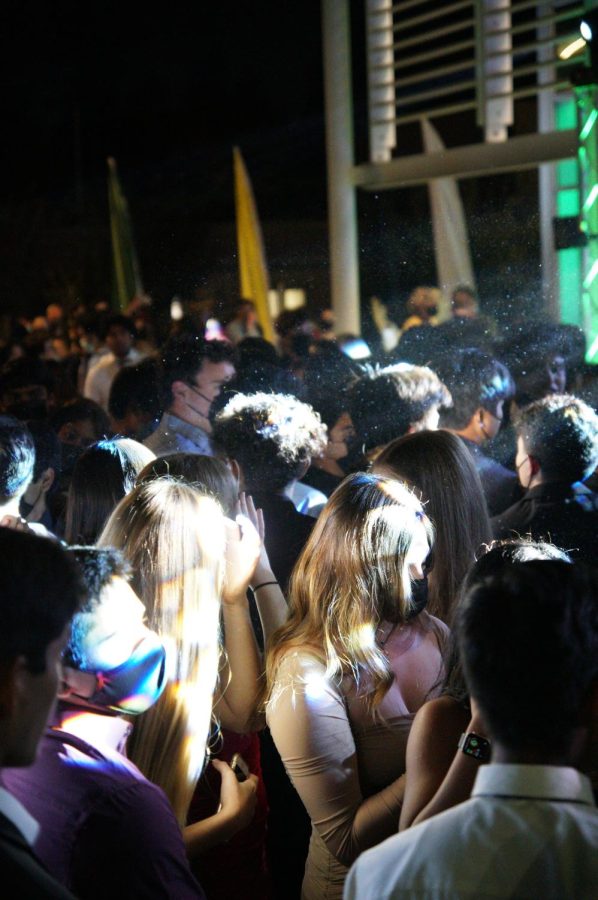 Students, illuminated by lights, dance to music during the Homecoming Dance. The dance was hosted a week after the Homecoming Game, in which the upper school football team hosted Marina High School.