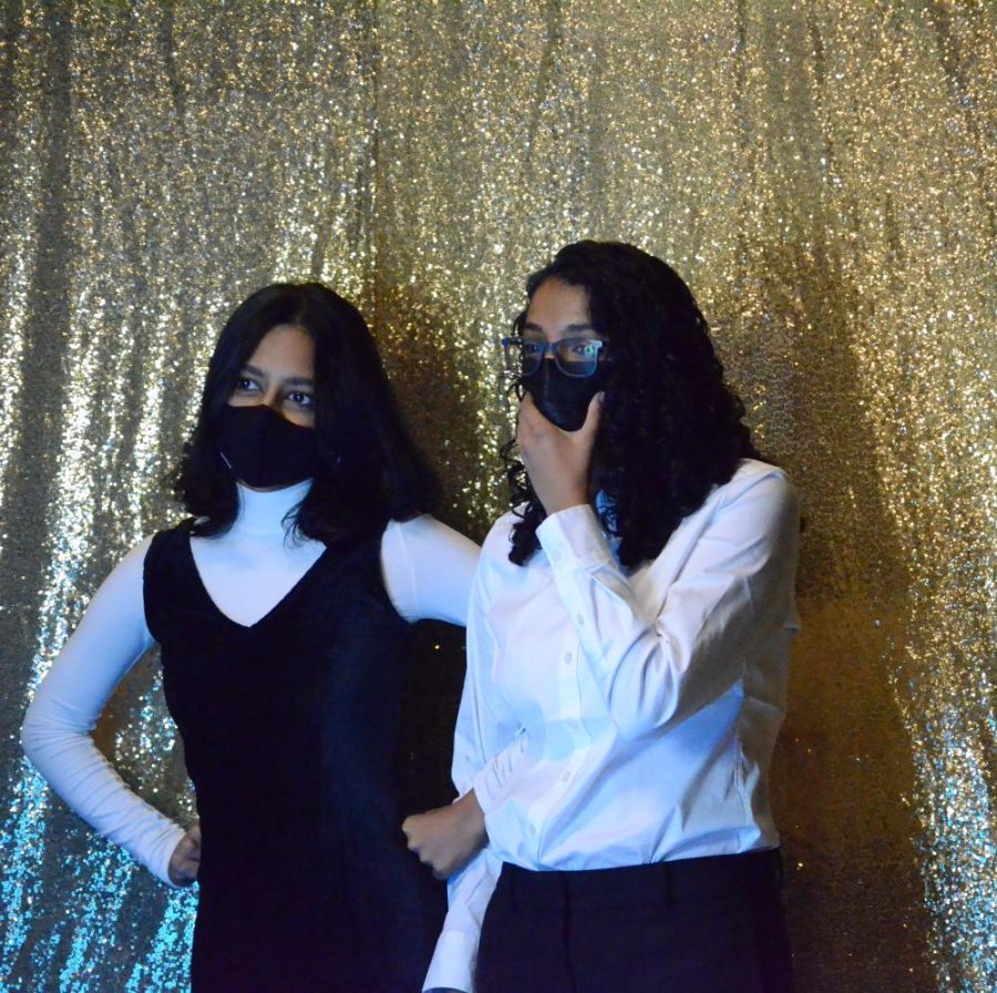 Freshmen Ananya Das and Sam Parupudi pose at the photo booth during the homecoming dance on Friday.
