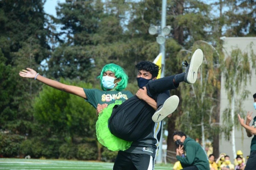 Sujith Pakala (12) holds Arvin Nidadavolu (12), who donned an emerald green wig and a lime green tutu. Both seniors performed in the senior lip sync. 