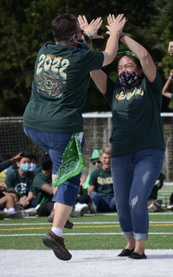 Director of Learning, Innovation and Design Diane Main and Director of Alumni Relations Kristina Alaniz cheer after guessing the right song in the game Name that Tune. Both Main and Alaniz represented the senior class.