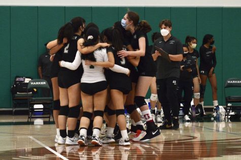 The junior varsity girls volleyball team rejoices in a huddle after their victory against Mercy High School. The Eagles won the match 25-23, 12-25, 15-10.