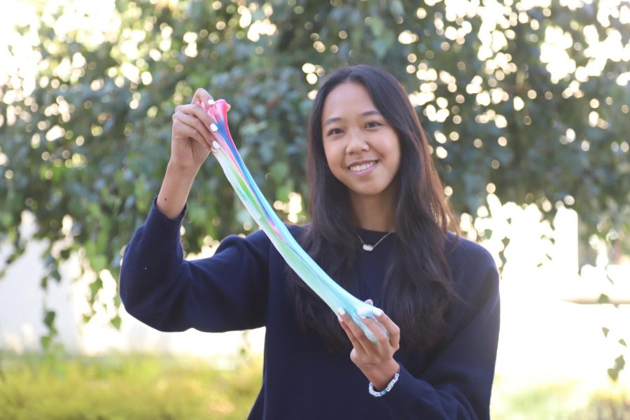 Andrea Thia (12) stretches some rainbow-colored slime, produced by her small business. Andrea started a slime business, Slimee Coffee in eighth grade, now with over 3,000 sales.