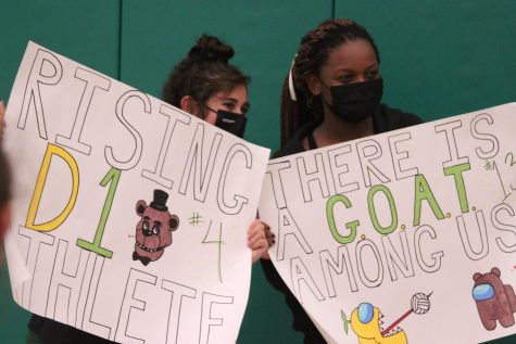 Tara Ozdemir (12) and Brooklyn Cicero (12) hold up signs made for their Senior Night. The team will play at Notre Dame this Tuesday at 6:30 p.m.