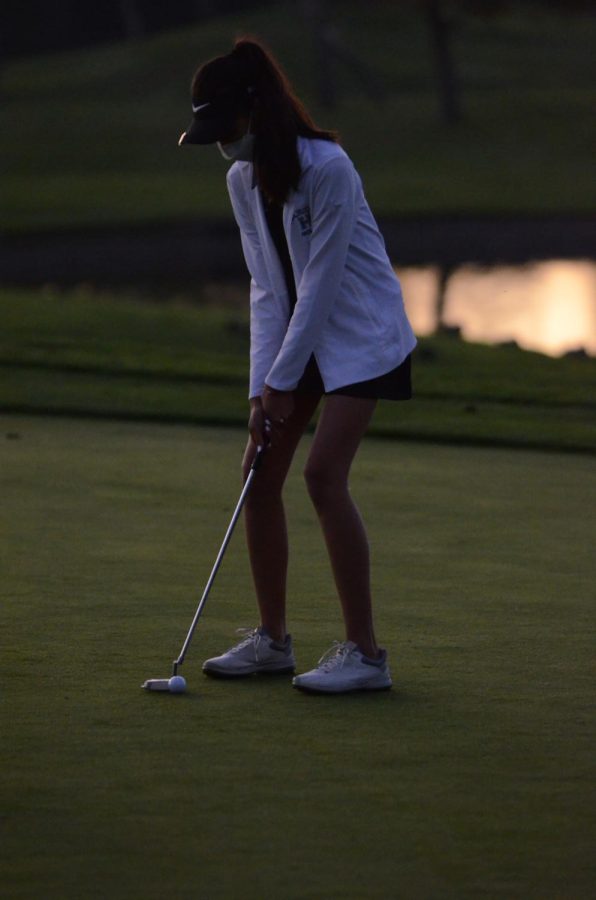 Andrea Thia (12) takes her final stroke during the varsity girls golf teams Senior Night on Nov. 12.