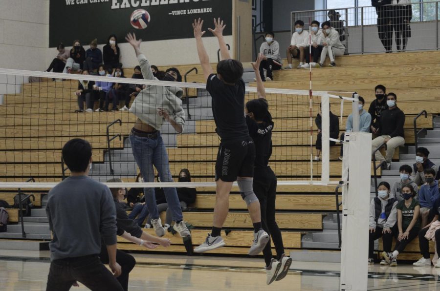 Spencer Mak (10) and Adrian Liu (10) block a hit from Vishnu Kannan (12) during the sophomores versus senior match in the “Hustle for Muscle” volleyball tournament. The seniors won the game 15-11.