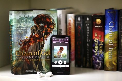The audiobook edition of “Chain of Gold” by Cassandra Clare borrowed from Sora stands next to the hardcover edition. This novel was the first audiobook I ever listened to, and it introduced me to a new form of consuming media that I had previously shunned due to misconceptions.