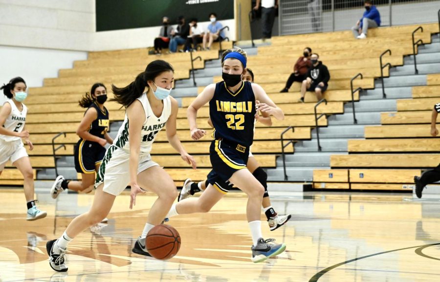 Cindy Su (12) dribbles the ball while running to the hoop.