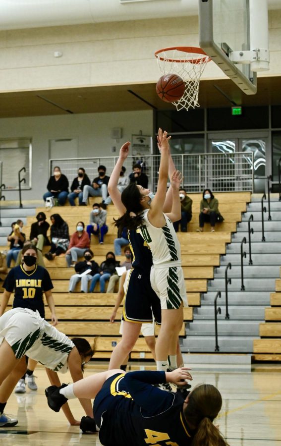 Alexa Lowe (12) in midair after attempting a floater shot.
