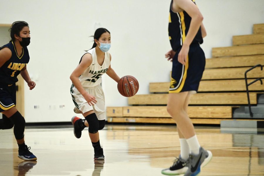 Isabella Lo (9) dribbles the ball while running down the court.