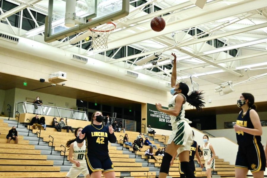 With arms outstretched, Anjali Yella (10) shoots a floater shot.