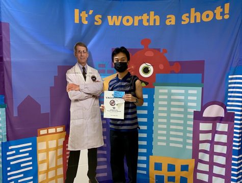 Kris Estrada (11) poses with a cutout of Dr. Anthony Fauci after receiving his Pfizer booster dose on Friday, Dec. 10, at the Valley Specialty Center in the Santa Clara Valley Medical Center. Pfizer authorized a single booster dose for 16 and 17-year olds on Thursday, Dec. 9.