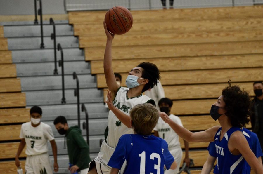 Caleb Tang (9) attempts a layup in the final quarter. While he missed the shot, the team was able to rebound and widen their lead in the final minutes of the game.