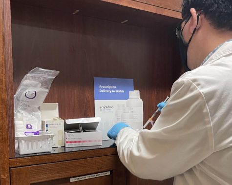 A pharmacist prepares a Pfizer booster shot on January 15 at the Los Gatos Safeway Pharmacy. The FDA approved of administration of the booster to children aged 12 to 15 on January 3.