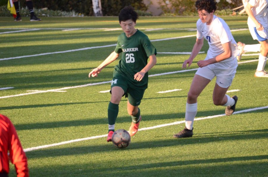 Jack Yang (10) dribbles the ball past a defender during the varsity boys soccer teams home game against Woodside Priory last Wednesday. “At the end, it was really tiring, but everyone pushed hard at the end and got the result,” Jack said.