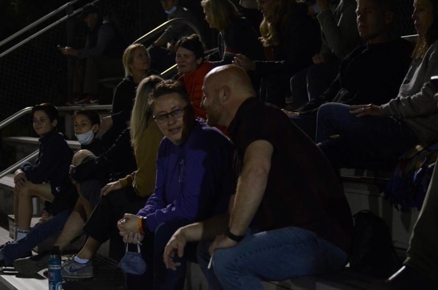 Senior class dean Christopher Hurshman and upper school LID director Diane Main converse in the stands.