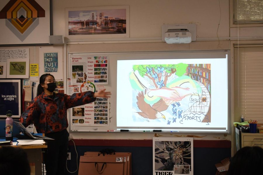 Art Club officer Michelle Liu (12) enthusiastically introduces a possible blueprint for the Quad mural. The Art Club intends to focus on themes of diversity of school life went painting the mural.
