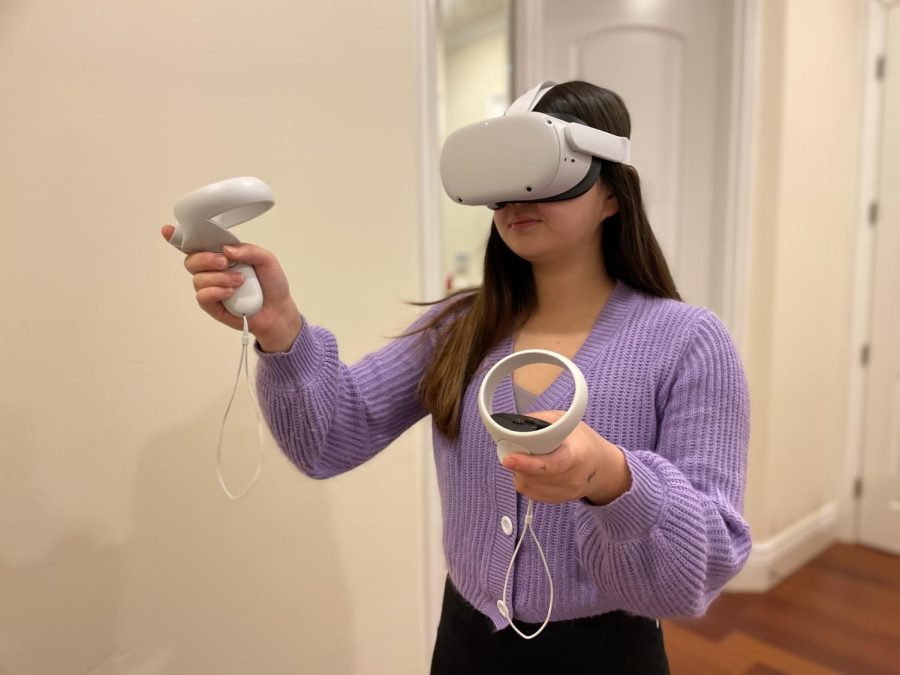 Eighth grader Tiffany Zhu uses a virtual reality (VR) headset and
handheld devices. VR lets consumers play immersive games and visit fictional spaces.
