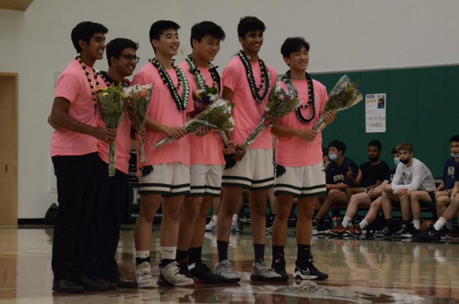 Seniors Kaden Kapadia, Ayan Nath, Charles Ding, John Zeng, Vedant Kenkare and Andrew Chen hold their bouquets and pose for their photo. Senior night took place on Feb. 11 and celebrated the graduating seniors on the team.