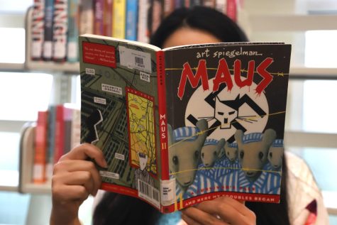 Michelle Liu (12) reads Maus, a graphic novel by Art Spiegelman about the Holocaust. A Tennessee school board banned the book for eighth graders in January, a move that threatens to erase the real history of the Holocaust. 