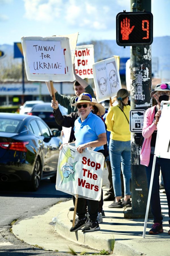 Protestors stand at the intersection of Winchester Blvd and Stevens Creek Blvd to protest the Russia-Ukraine conflict on March 6. Russia invaded Ukraine on Feb 24. 