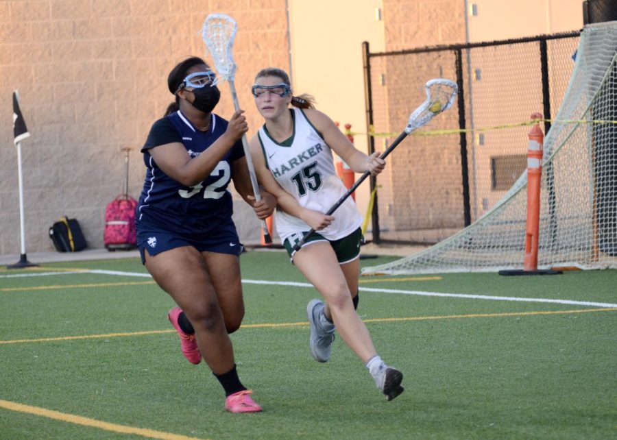 Kyra Hawk (11) runs with the ball while avoiding a Notre Dame defender. Kyra scored five out of Harkers seven goals during the game.