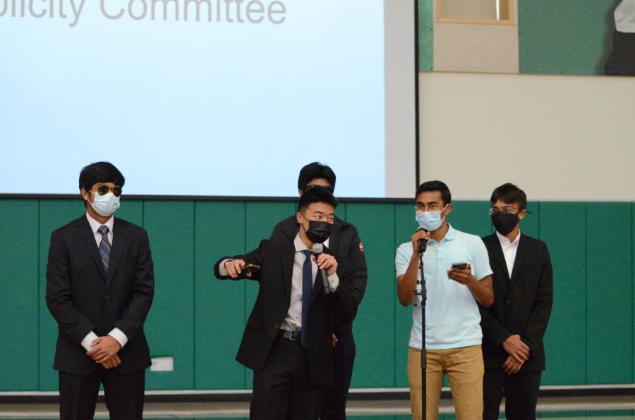 Publicity committee members Daniel Lin (10) and Sasvath Ramachandran (12) announce the upcoming Hoscars show tomorrow. Dressed as security, sophomores Adi Jain, Om Tandon and Veyd Patil accompanied the two presenters.