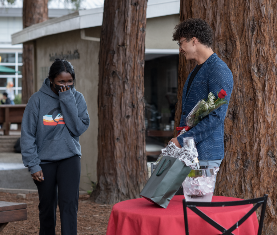 Kai Burich (12) sets up a table with a rose and music in the graduates grove. His promposal was designed for Malar Bala (12). 