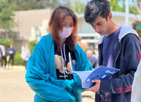 Zubin Khera (11) and Vivian Bi (11) read writing in the latest issue of the Harker Eclectic Literary Magazine (HELM), which was produced by students and focused on the theme of renaissance this year. HELM often features student-written poetry, creative writing and miscellaneous forms of art. 