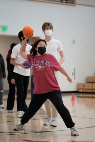 Jessica Tang (11) throws a ball at the senior team during their dodgeball game. The seniors ultimately defeated the juniors. 
