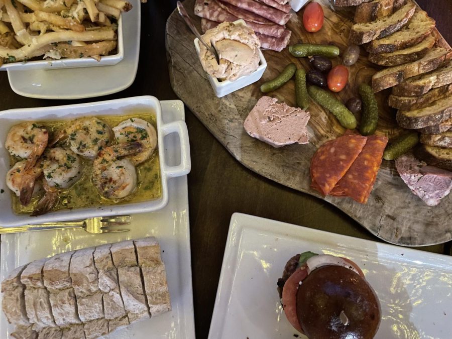 A spread of garlic shrimp, beef sliders, french fries and a charcuterie board from WeHo Bistro. The restaurant was founded by Jeff Douek in the summer of 2011.