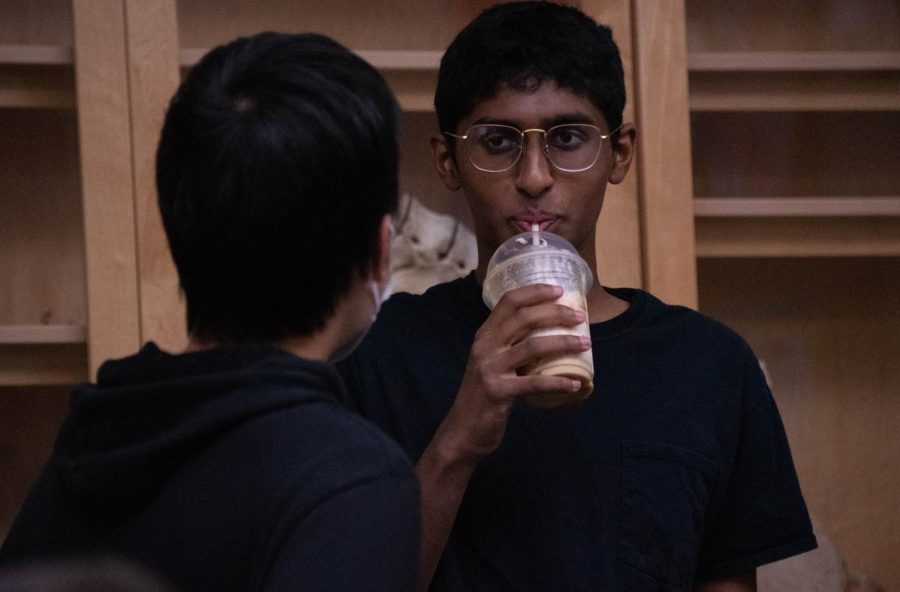 Rishi Cherukuri (11) sips a Starbucks frappuccino while talking to Stephen Xia (11) during a break in Teacher Johnsons Honors Biology class. Previously, students were required to step out of the classroom to drink or eat.