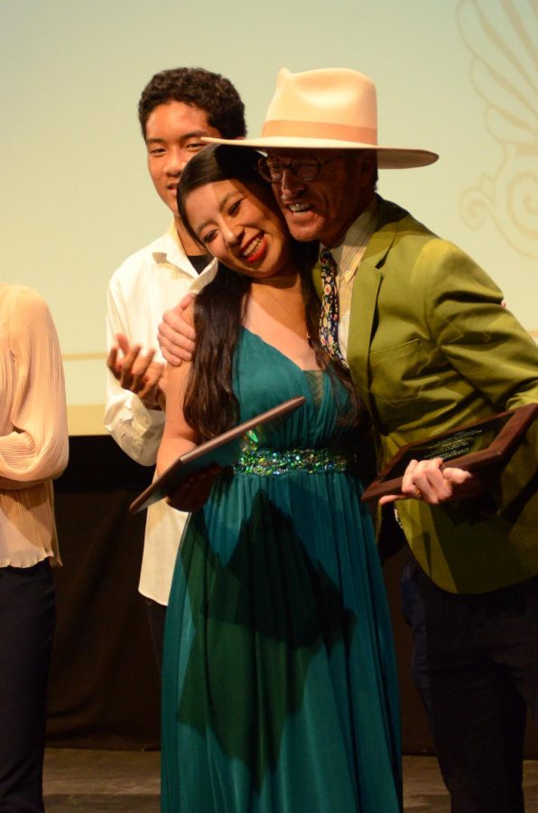 Upper school dance teacher Karl Kuehn gives dance certificate senior Irene Yuan a side-hug during the awarding ceremony. All Certificate seniors received a plaque, with a small speech, from their corresponding performing arts teachers.