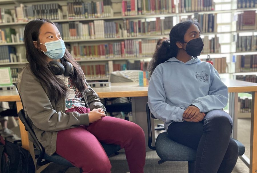 Juniors Hita Thota and Karina Chen watch the screen as Robin Ha presents. Upper school students gathered in the library classroom to meet the author, while middle school students attended over Zoom.