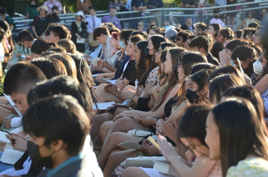 Students from the classes of 2022 and 2023 listen as Cantilena performs an arrangement of Youre My Best Friend by John Deacon during baccalaureate on Davis Field. “[Performing at baccalaureate] is definitely a very bittersweet occasion,” Cantilena leader Teresa Cai (‘22) said. “I’ll definitely miss being at high school and the people Im with, but Im excited to go off and make the people here proud.”