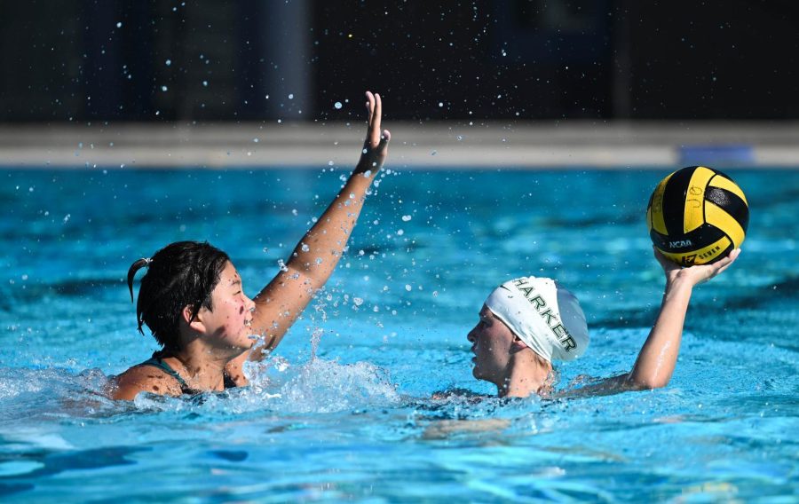 Abby Lim (10) raises an arm to block Kyra Hawk (12) in a passing drill. Girls water polo practiced on the morning of Aug. 13, one of two Saturday practices.