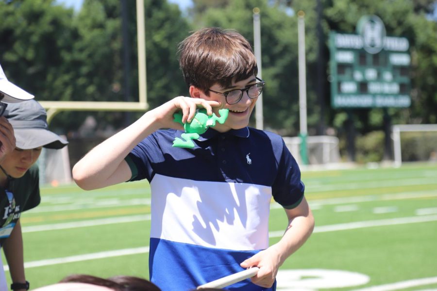 Tom Campisi (9) smiles with a stuffed frog during a frosh class field day activity. This activity required advisories to only use sticks to raise several stuffed animals. 