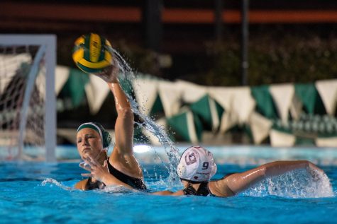 Pressured by a Castilleja gator, senior Kyra Hawk passes the ball to a fellow teammate to allow Harker to be in a scoring position. The varsity girls water polo team fell to Castilleja in a close match on Tuesday.